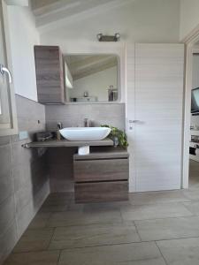 a bathroom with a sink and a mirror at Attico Casa ReGa - private parking and bbq in Quartu Sant'Elena +21 photos