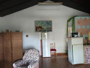 a living room with two chairs and a refrigerator at Casita del Romero Ronda in Ronda