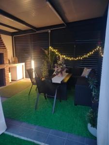 a living room with a table and a couch at Green Nest in Laktaši