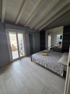 a bedroom with a bed and a large mirror at Attico Casa ReGa - private parking and bbq in Quartu Sant'Elena