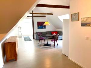 a living room with a table and chairs and a couch at Nygård Apartments in Klagstorp