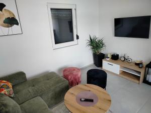 a living room with a couch and a table at Green Nest in Laktaši