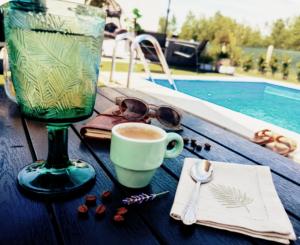 a table with a cup of coffee and a wine glass at Green Nest in Laktaši +4 photos