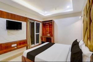 a bedroom with a white bed and a window at Cross Lane- A Boutique Hotel-Kota in Kota +10 photos