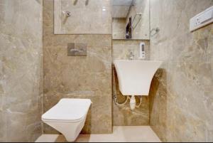 a bathroom with a white toilet and a sink at Cross Lane- A Boutique Hotel-Kota in Kota