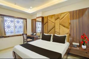 a hotel room with a large bed and a desk at Cross Lane- A Boutique Hotel-Kota in Kota