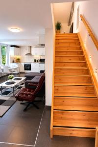 a staircase leading to a kitchen and a living room at Nordic Home Finja in Hässleholm