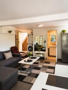 a living room with a couch and a table at Nordic Home Finja in Hässleholm
