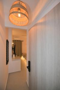 a hallway with a large light fixture on a wall at kleris apartment 3 in Tinos