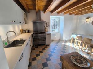 a kitchen with a stove and a counter top at Fajureya House in Vaumeilh +19 photos