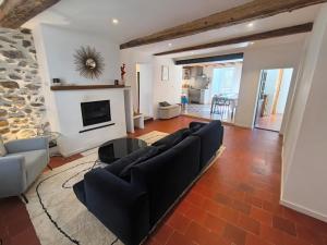 a living room with a couch and a fireplace at Fajureya House in Vaumeilh