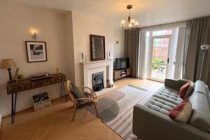 a living room with a couch and a fireplace at Charming Lisburn Flat with private parking in Lisburn