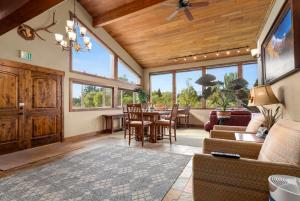 a living room with a table and chairs at Duck Inn Lodge in Whitefish
