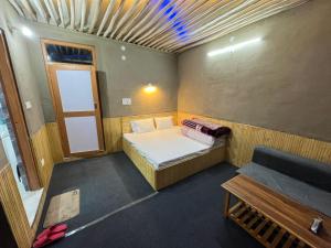 a small room with a bed and a window at Moon Lake Hotel, Nako in Nako