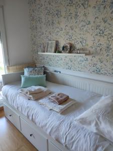 a bed with two towels on it in a bedroom at Marzan Playa in Foz +33 photos