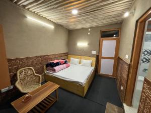a small room with a bed and a chair at Moon Lake Hotel, Nako in Nako +22 photos