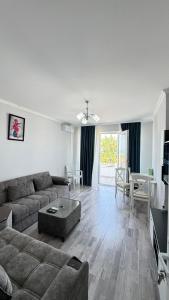 a living room with a couch and a table at Astara Villa Boutique Hotel in Astara