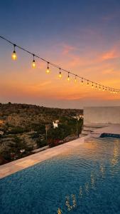 a group of lights hanging over a swimming pool at Seeq view in Sayq