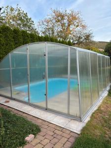 a glass greenhouse with a swimming pool inside at PENZION VLASTA in Zlín