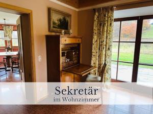 a living room with a fireplace in a house at VILLA SEEBERG - by "Schloss Gessenberg" luxurious vacation home with lake and mountain views, suitable for families and friends in Petting