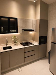 a kitchen with a sink and a stove top oven at Seeq view in Sayq