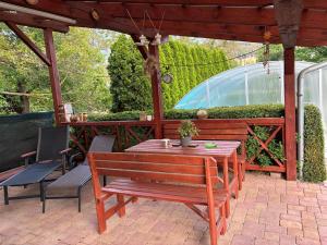 a wooden table and bench on a patio at PENZION VLASTA in Zlín