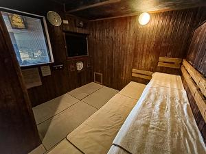 a room with two beds in a wooden cabin at Dormy Inn Hirosaki in Hirosaki