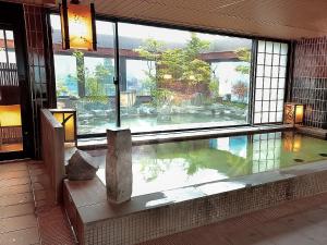 a room with a pool of water in a building at Dormy Inn Hirosaki in Hirosaki