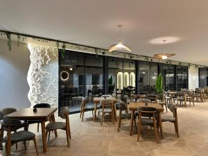 a restaurant with wooden tables and chairs and windows at SUPREME Luxury in Ulcinj