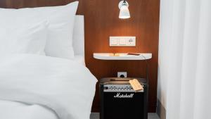 a room with a bed and a desk next to a bed at Ruby Marie Hotel Vienna by IHG in Vienna