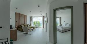 a living room with a couch and a table and a mirror at Boutique Hotel Nika in Ohrid +37 photos