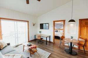 a living room with a couch and a table and a bed at Mt Stimson Suite Work-From-Anywhere-Ready in Kalispell