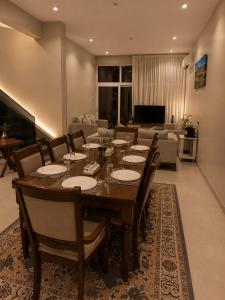 a dining room with a table and a living room at Seeq view in Sayq