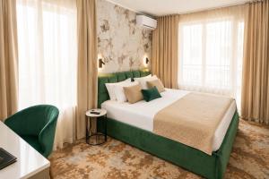 a hotel room with a large bed and windows at Hotel Central in Sunny Beach +86 photos