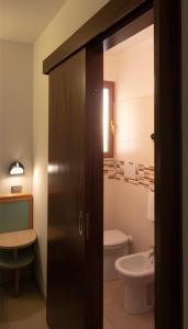 a bathroom with a toilet and a sink at Hotel Ristorante Selene in Alba Adriatica