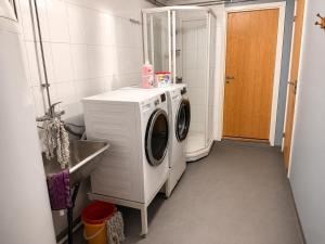 a washing machine in a bathroom with a sink at KB - Waterfront Villa Sørvågen in Moskenes