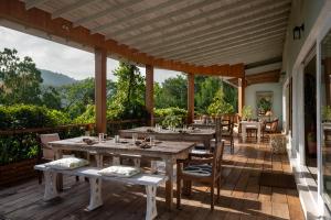 a patio with tables and chairs on a deck at Rukgala Retreat in Digana
