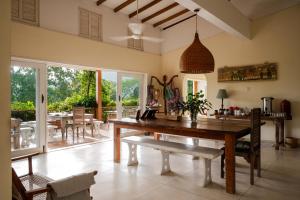 a dining room with a large wooden table and chairs at Rukgala Retreat in Digana