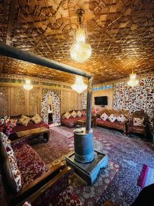 a living room with a couch and a fireplace at Smith Palace Group Of Houseboats in Srinagar