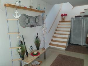 a room with a staircase with a table and a stair case at Casa Tim in Tulcea