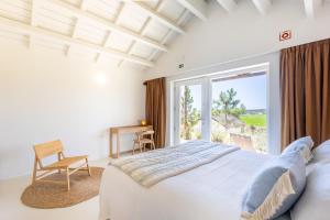 a bedroom with a bed and a large window at Quinta Amala in Melides +48 photos