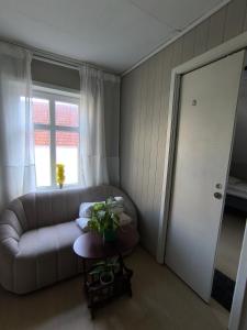 a living room with a couch and a window at Stavangerliving in Stavanger