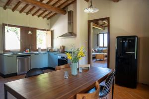 a kitchen with a wooden table and a dining room at Boutique Bio Agriturismo Casale San Cristoforo in Città di Castello