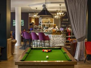 a bar with a pool table in a restaurant at Mercure Rambouillet Relays Du Château in Rambouillet