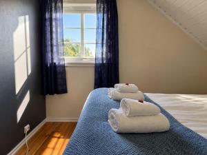 a bedroom with towels on a bed with a window at Myranhuset - Amazing View in Moskenes