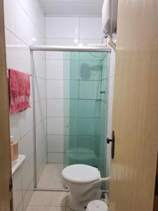 a bathroom with a toilet and a glass shower at República Mandala - Quarto duplo 2 in Ouro Preto