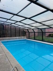 an overhead swimming pool with a roof over it at Le Sart de Bouland in Frasnes-lez-Anvaing