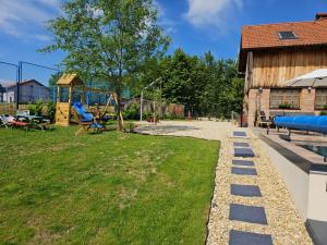 a yard with a playground and a play equipment at Vila RAMI in Donja Poljana