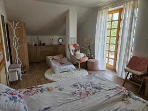 a bedroom with two beds and a chair and a window at Vila RAMI in Donja Poljana +63 photos