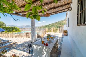 a table on the patio of a house with a view at La Encina in Lanjarón